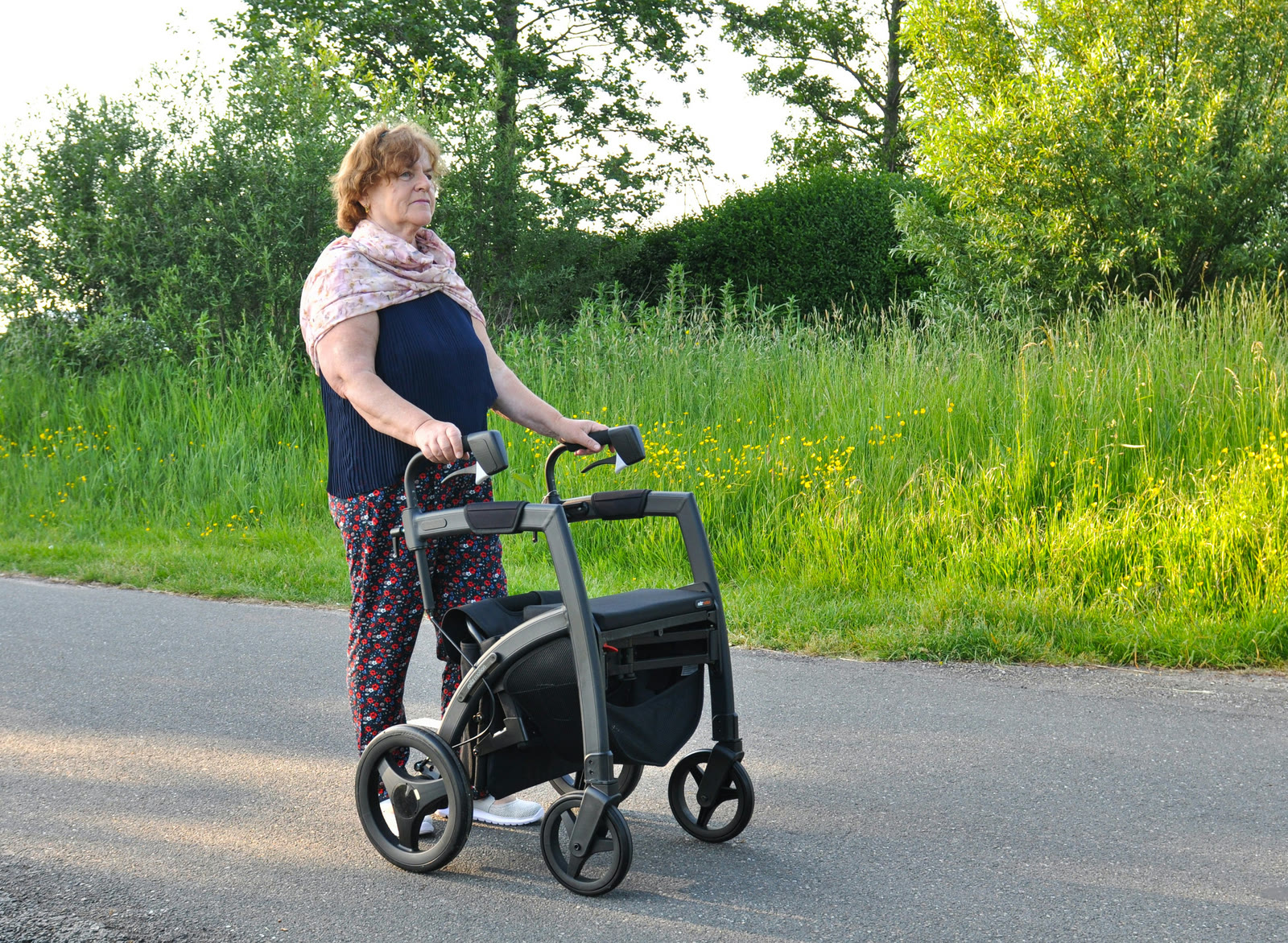 Person using a walker on a forest path